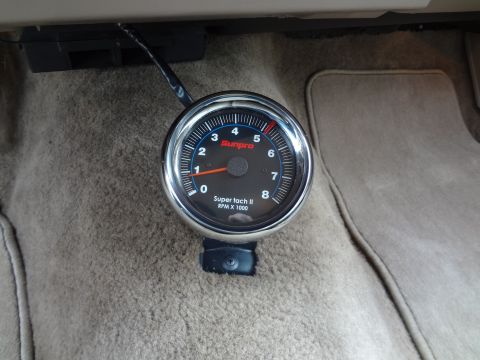 1993 Mercury Grand Marquis - A Sunpro Super tach II gauge is visible, mounted on the floor of a vehicle.