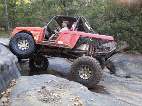 1967 Ford Mustang - This heavily modified buggy is shown off-roading over large rocks.