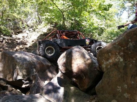 1967 Ford Mustang - Custom off-road buggy tackles a rocky obstacle on a challenging trail.