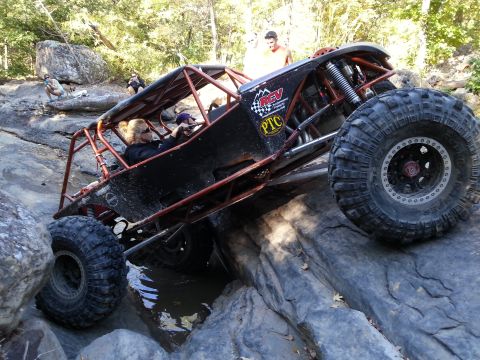 1967 Ford Mustang - This off-road buggy is tackling a challenging rocky obstacle course with water and large boulders.
