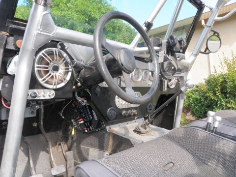 1961 International Scout 800 - Custom interior of an off-road vehicle with roll cage and aftermarket audio equipment.