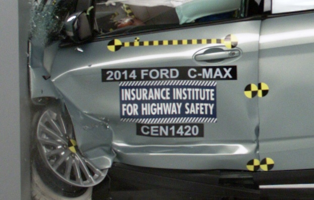 Silver 2014 Ford C-Max side view with damage and safety institute labels