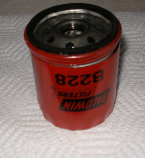 2010 Hyundai Genesis - A Baldwin Filters B228 oil filter is shown close-up against a white textured background.