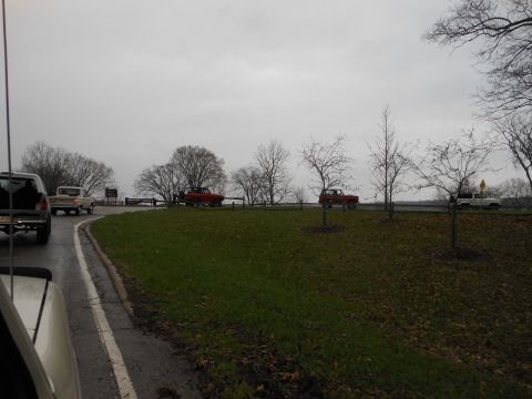 1995 Ford Bronco - Several vehicles, including a 1995 Ford Bronco, are seen on a road during an overcast day.