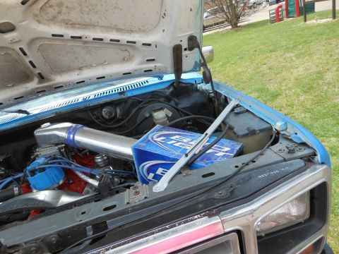 1995 Ford Bronco - A box of Bud Light sits in the engine bay of a vehicle.
