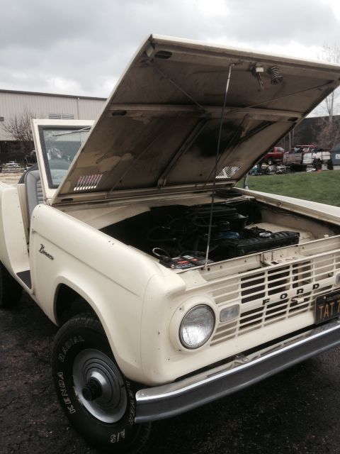 1995 Ford Bronco - This first-generation Ford Bronco, likely from the late 1960s, has its hood open, revealing the engine bay.