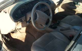 1994 Ford Taurus - Interior view of a 1994 Ford Taurus, highlighting the dashboard and seating area.
