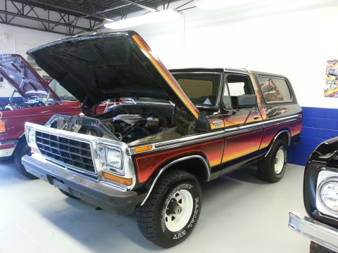 1995 Ford Bronco - This 1978 Ford Bronco features a distinctive gradient paint job and its hood is open.