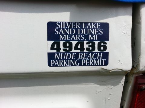 1995 Ford Bronco - A parking permit sticker is affixed to the white exterior of a vehicle.