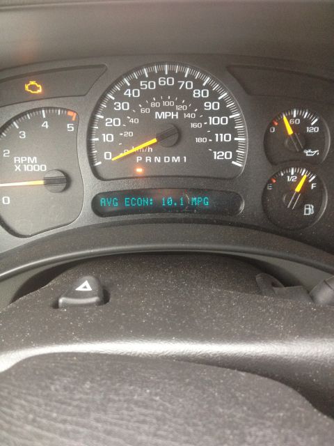 2006 Chevrolet Silverado 2500 - The dashboard shows a check engine light and average fuel economy of 10.1 MPG.