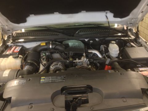2006 Chevrolet Silverado 2500 - The engine bay of a 2006 Chevrolet Silverado 2500 is visible with the hood open, revealing the diesel engine.