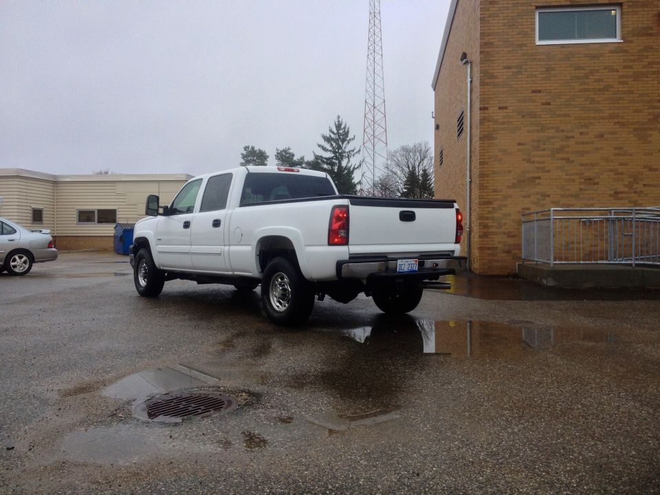 White 2006 Chevrolet Silverado 2500 pickup truck, rear 3/4 view