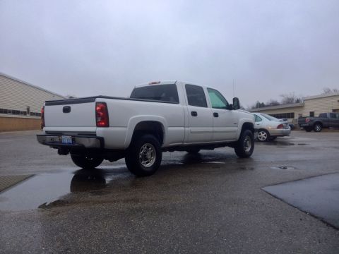 2006 Chevrolet Silverado 2500 - White 2006 Chevrolet Silverado 2500 crew cab pickup truck seen from the rear three-quarter angle.