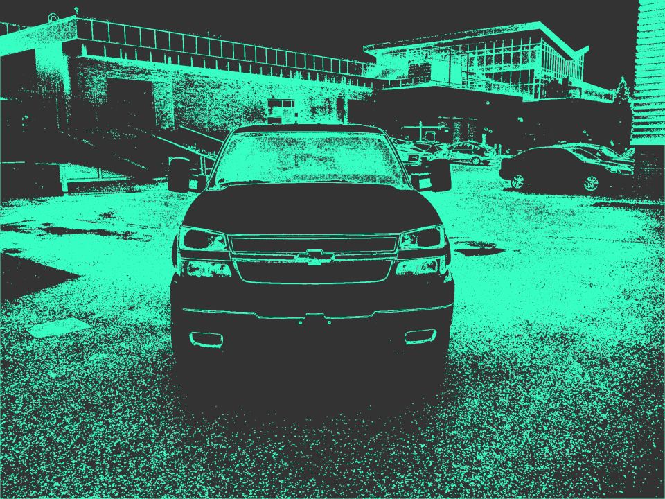 Front view of a 2006 Chevrolet Silverado 2500 parked in front of a building