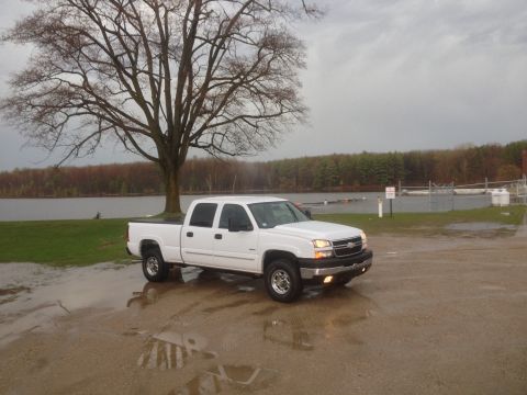 2006 Chevrolet Silverado 2500 - White 2006 Chevrolet Silverado 2500 parked near a lake on a cloudy day.