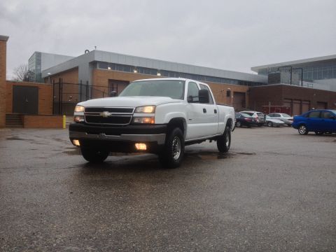 2006 Chevrolet Silverado 2500 - White 2006 Chevrolet Silverado 2500 pickup truck parked outdoors on a cloudy day.