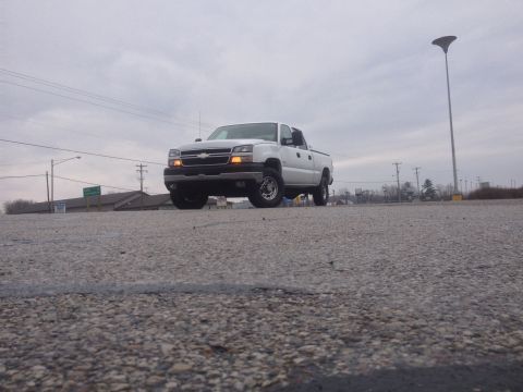 2006 Chevrolet Silverado 2500 - This 2006 Chevrolet Silverado 2500 is captured from a low angle, its front-end details under an overcast sky.
