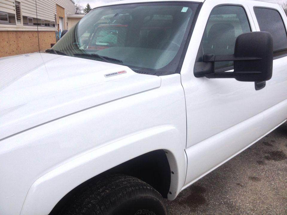 White pickup truck with Duramax Diesel badge on fender. Looks like a 2006 model
