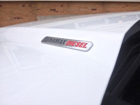2006 Chevrolet Silverado 2500 - Close-up of a Duramax Diesel badge on the fender of a white vehicle.