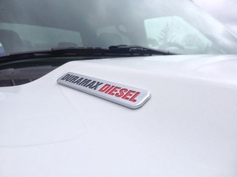 2006 Chevrolet Silverado 2500 - A close-up of the Duramax Diesel badge on a white vehicle's hood.
