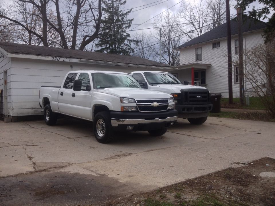 2006 Chevrolet Silverado 2500 parked next to a black Ford truck