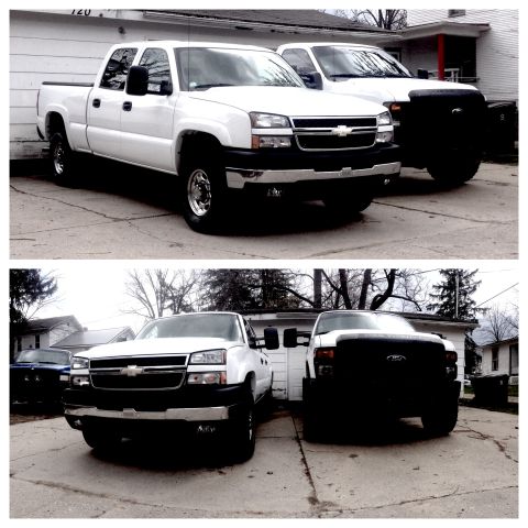 2006 Chevrolet Silverado 2500 - Two white pickup trucks are parked in a driveway. The front truck is a 2006 Chevrolet Silverado 2500.