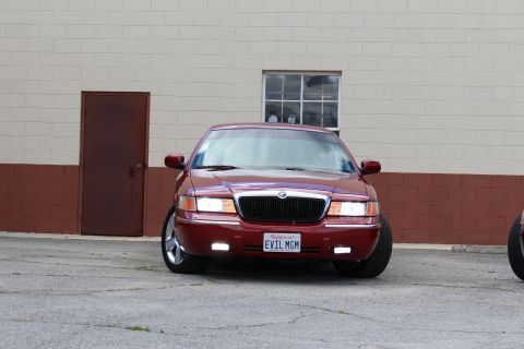 2002 Mercury Grand Marquis - A red 2002 Mercury Grand Marquis is shown from the front, a custom license plate.