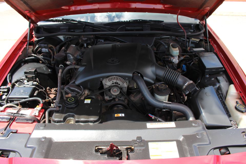2002 Mercury Grand Marquis engine bay with red exterior paint visible