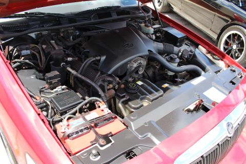 2002 Mercury Grand Marquis - Engine bay of a 2002 Mercury Grand Marquis, showing the engine and battery.