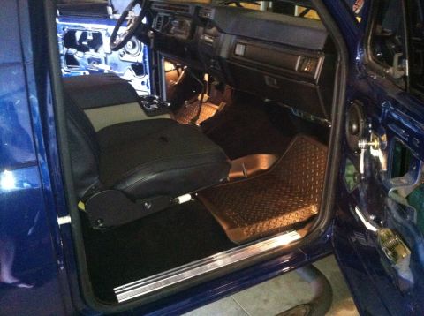 1982 Ford Bronco - Interior of a blue vehicle, likely from the early 1980s, with seats and dashboard visible.