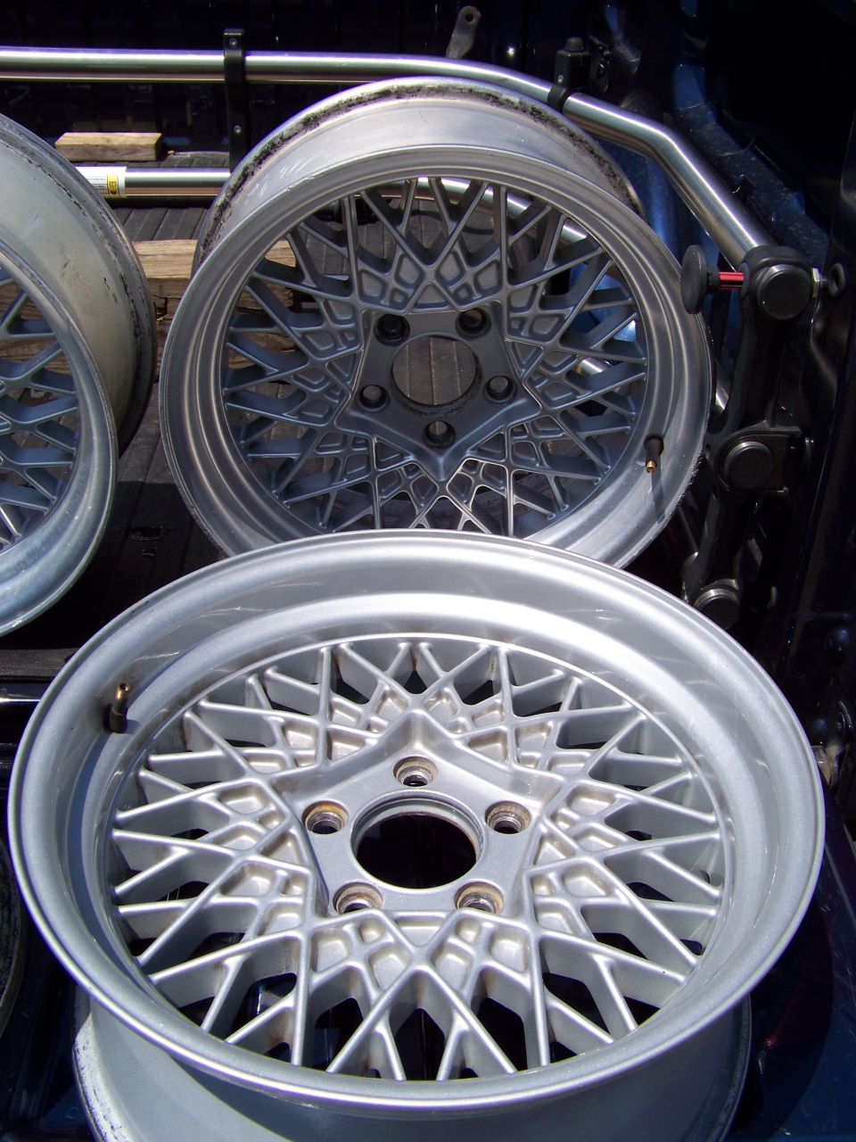 Silver wire wheels with a starburst pattern