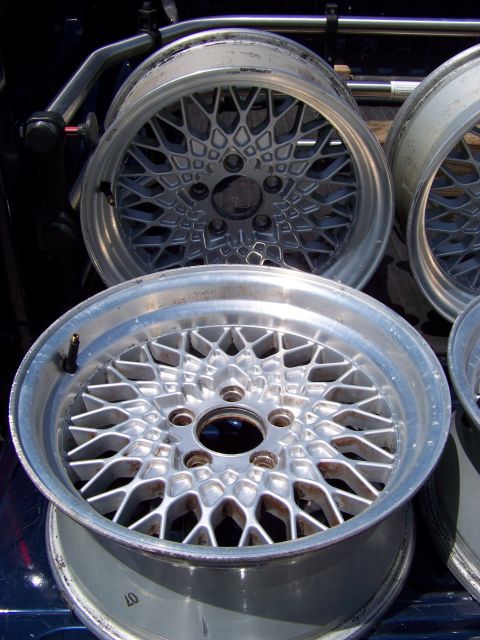 1999 Mercury Grand Marquis - Several mesh alloy wheels are piled up, ready for transport or installation.