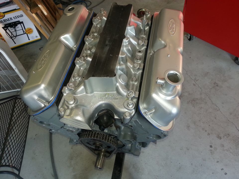 Silver Ford V8 engine with a black intake manifold and silver valve covers