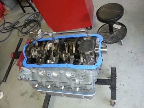 1994 Ford Bronco - The engine block is disassembled, showing the crankshaft and internal components with a blue gasket seal.