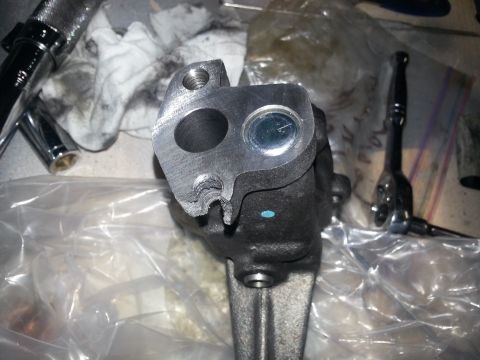 1994 Ford Bronco - A damaged engine part is shown with tools nearby, suggesting a repair or replacement process.