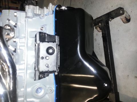 1994 Ford Bronco - Close-up view of a vehicle engine block and its freshly installed oil pan.