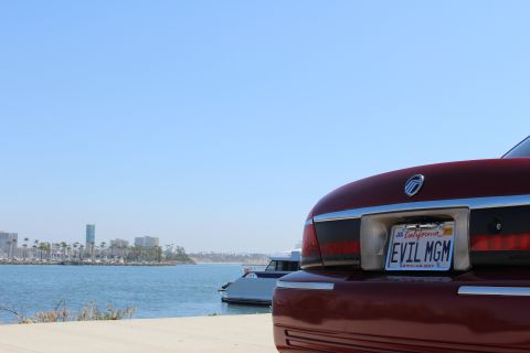 2002 Mercury Grand Marquis - Rear view of a 2002 Mercury Grand Marquis with a custom license plate parked near a harbor.