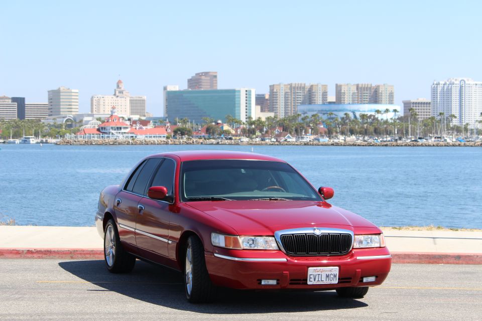 Red 2002 Mercury Grand Marquis with custom "EVIL MGM" license plate