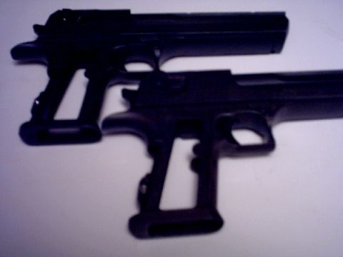1995 Ford Bronco - Two black handguns are shown in this image.
