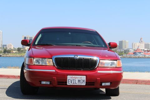2002 Mercury Grand Marquis - A red 2002 Mercury Grand Marquis is shown from the front, a custom license plate that reads 'EVIL MGM'.