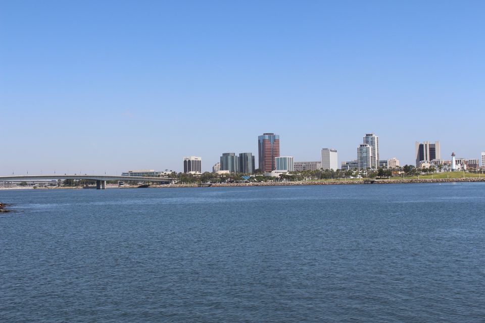 Waterfront view of a city skyline with a bridge in the distance