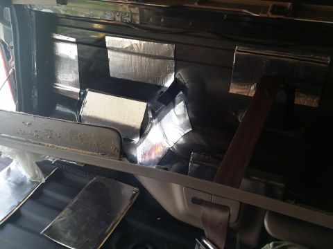 1994 Ford Bronco - Sound deadening material is being applied to the interior of a vehicle.