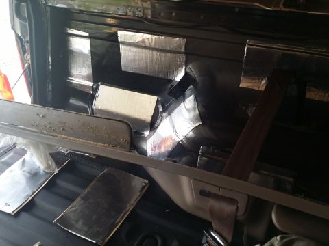 1994 Ford Bronco - Soundproofing material being applied to the interior panels of a vehicle.