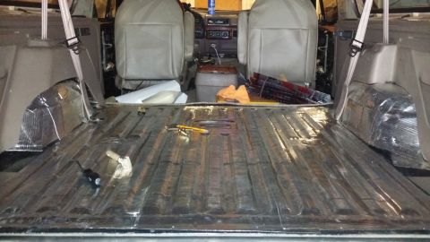 1994 Ford Bronco - Soundproofing installation in progress on the floor of a 1994 Ford Bronco.