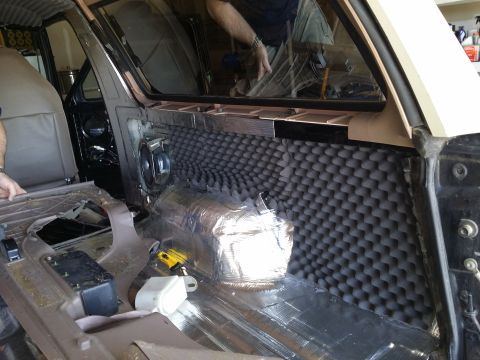 1994 Ford Bronco - Soundproofing installation in a 1994 Ford Bronco interior, showing door panel and floor insulation.