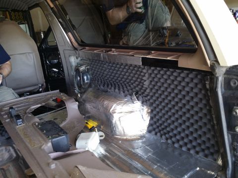 1994 Ford Bronco - Soundproofing materials are being installed inside the vehicle's interior.