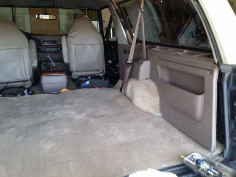 1994 Ford Bronco - The interior of a 1994 Ford Bronco is shown, with a focus on the front seats and the carpeted cargo space.