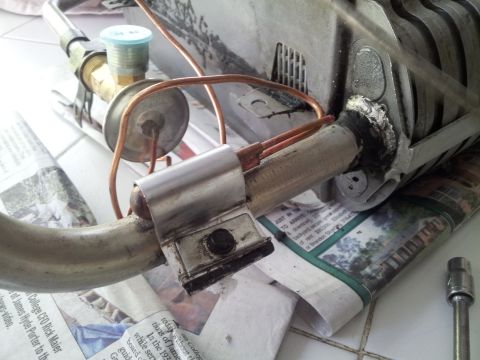 1976 Ford Ranchero - Close-up of an air conditioning component, likely an expansion valve and part of a condenser, with copper tubing.