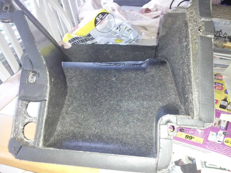 Interior car air conditioning ductwork with insulation and some packaging behind it