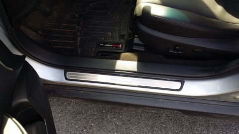 2014 Subaru Outback - Close-up of a car's interior door sill and floor mat, showing the WeatherTech branding.